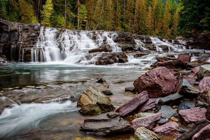 Waterfall flowing over rocks in a forest