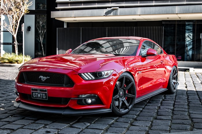 Red Ford Mustang GT with custom rims