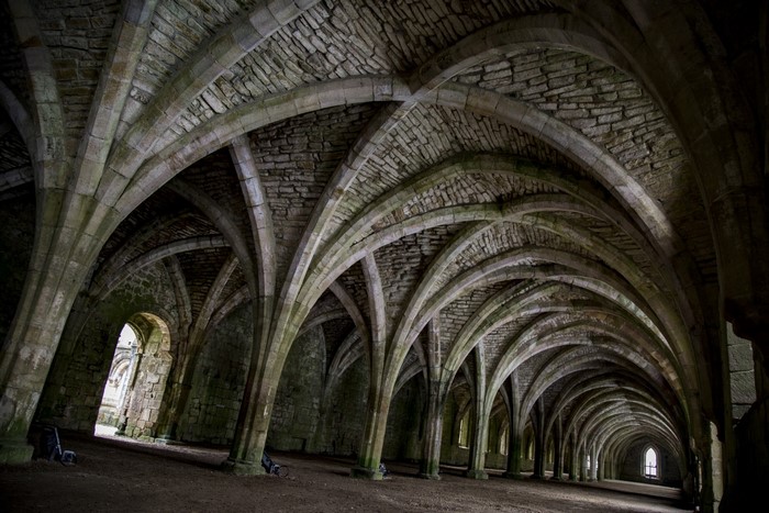 Interior of Fountains Abbey with stone arches