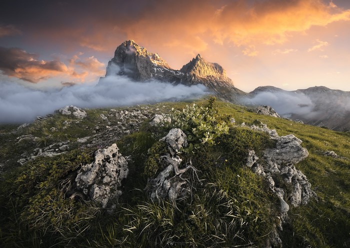 Mountain peaks shrouded in clouds at sunset