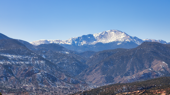 Snow-capped mountains in Colorado under a clear blue sky