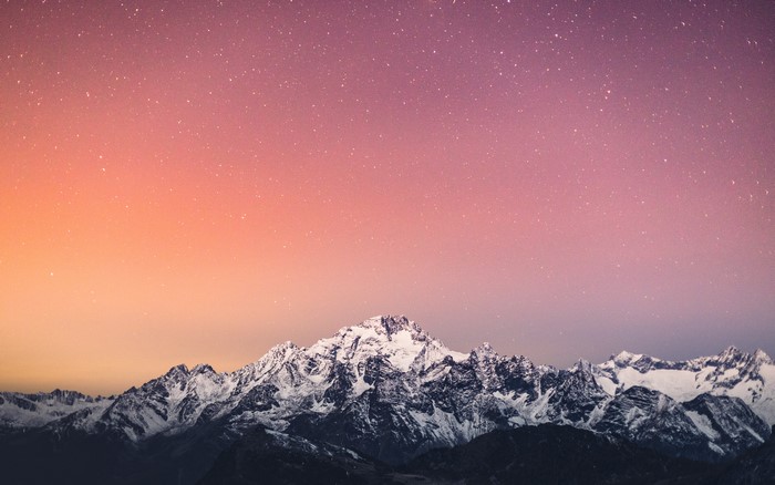 Snowy mountains under a starry sky