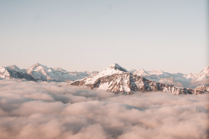 Snowy mountains above clouds