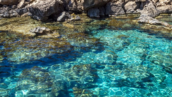 Clear turquoise water near rocky shore