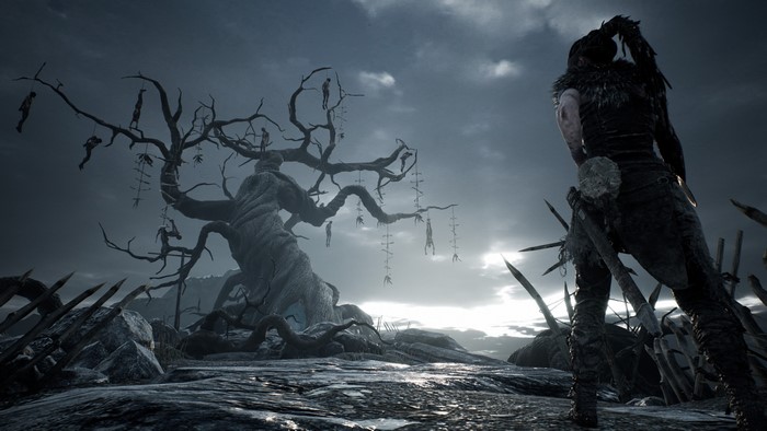 Senua from Hellblade: Senua's Sacrifice with hanged corpses on a tree