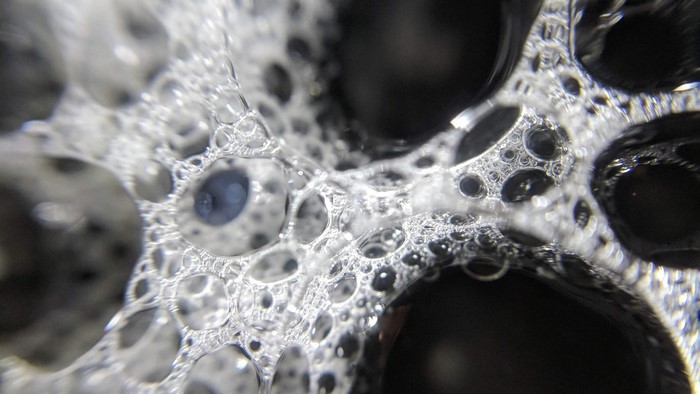 Macro view of soap bubbles and liquid