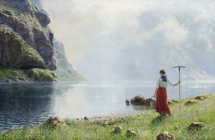 Woman with rake by a fjord