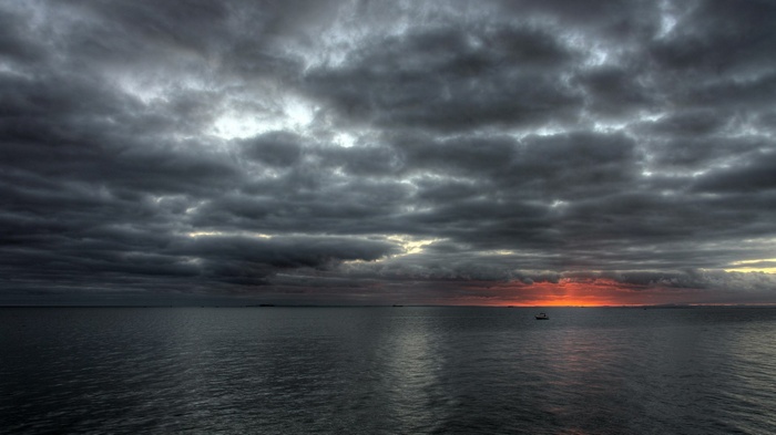 Dark Clouds Over the Ocean at Sunset