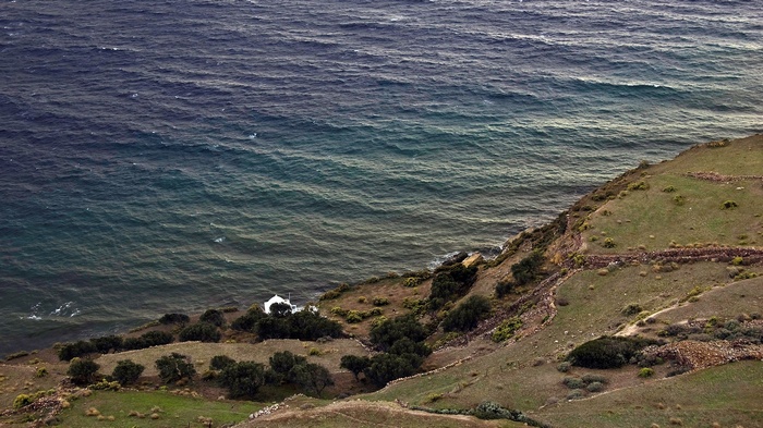 Coastal landscape with a small white building by the sea