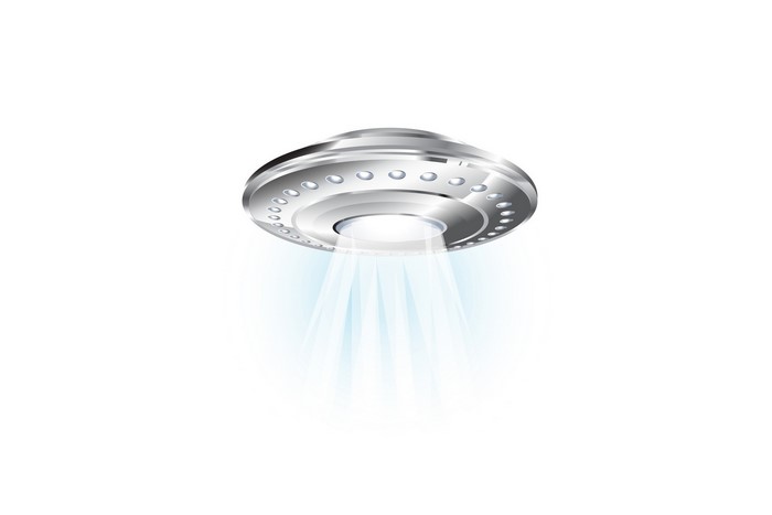 Silver UFO with blue light beams on white background