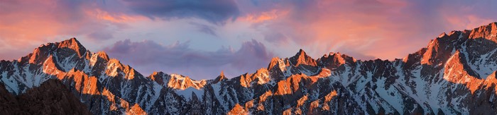 Mountain range at sunrise with pink clouds