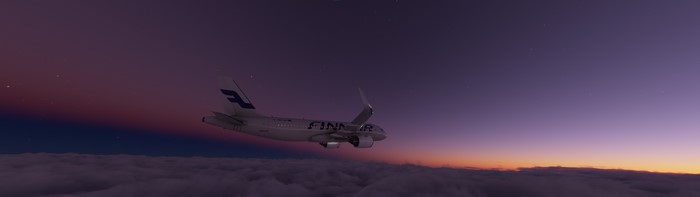 Finnair Airbus A320 flying above clouds at sunset