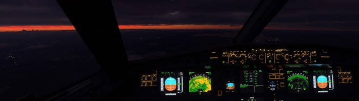 Cockpit view of an Airbus A320 during sunset flight