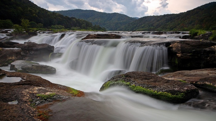 Waterfall cascading over rocks in a mountain valley