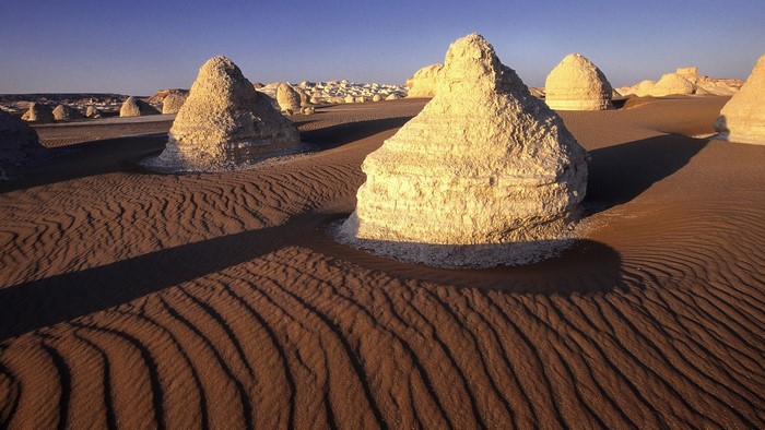 Desert landscape with chalk formations and sand dunes