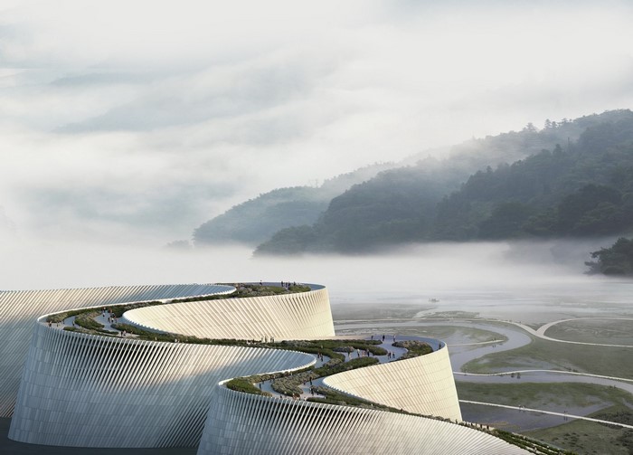 Modern architecture with winding paths in misty mountains