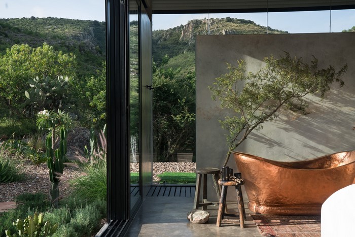 Modern house with outdoor bathroom and mountain view