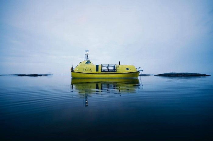 Yellow boat on calm water with islands