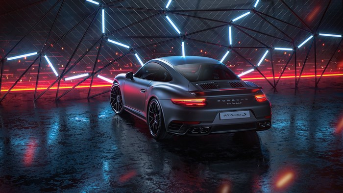 Matte gray Porsche 911 Turbo S in a neon-lit garage