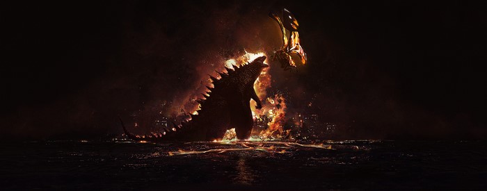 Godzilla and Mothra fighting amidst fire