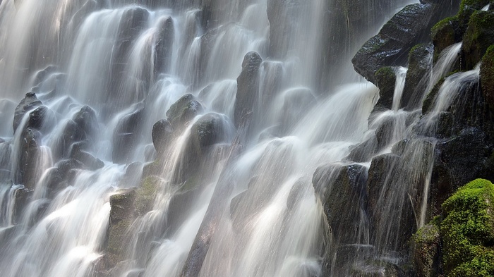 Waterfall cascading over mossy rocks