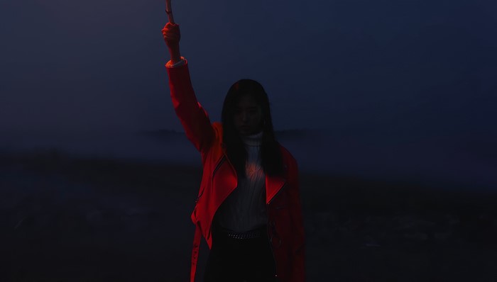 Olivia Hye from LOONA holding a flare