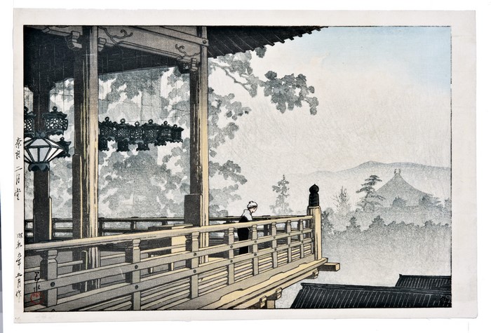 Balcony overlooking a misty landscape with a pagoda