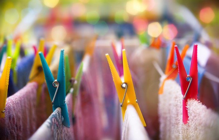 Colorful clothespins on a laundry line with bokeh