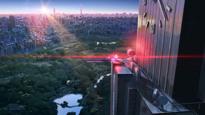 Cityscape at sunrise with a park and tall buildings