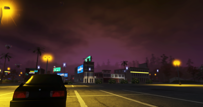 Black car in a parking lot at night with city lights