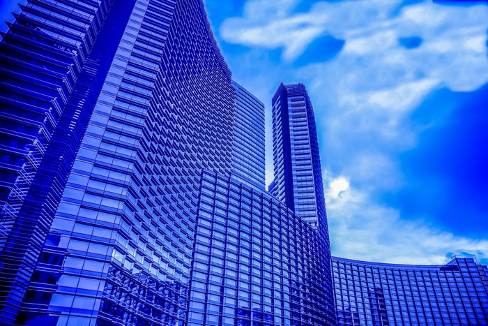 Blue glass skyscrapers against a cloudy sky