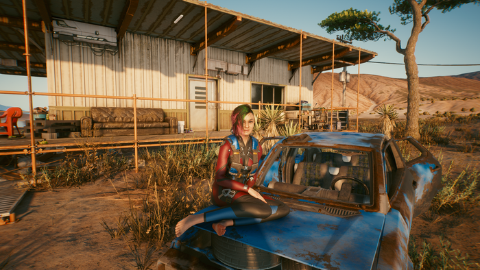 Judy Alvarez from Cyberpunk 2077 sitting on a car