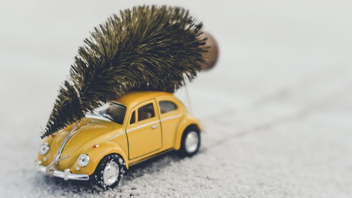 Yellow Volkswagen Beetle toy car with Christmas tree
