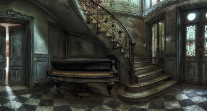 Abandoned house interior with grand piano and staircase