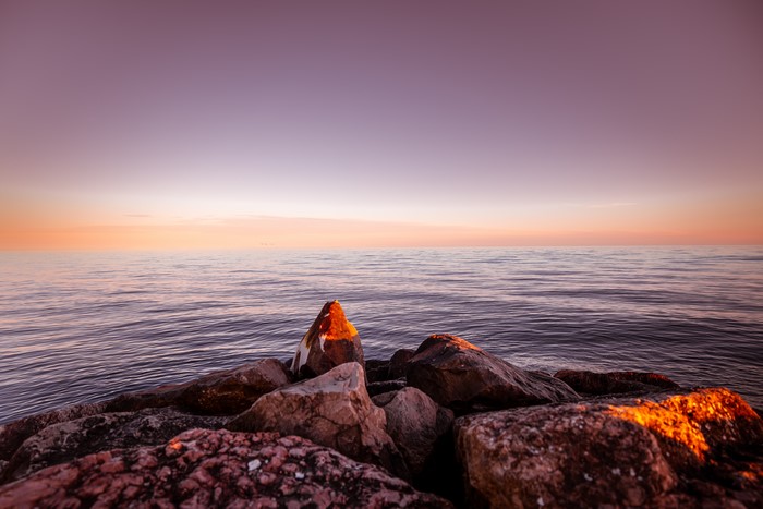 4K rocks on sea at sunset
