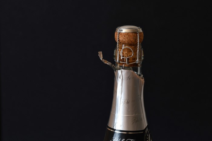 Champagne bottle with cork and wire cage