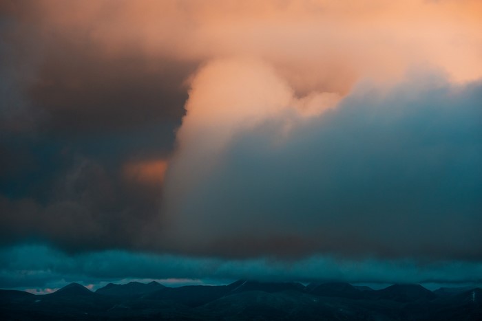Dark clouds over mountains at dusk