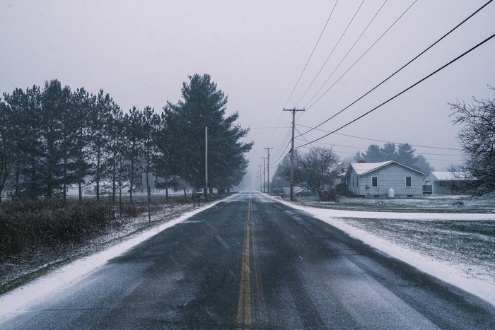 Winter road with snow and houses