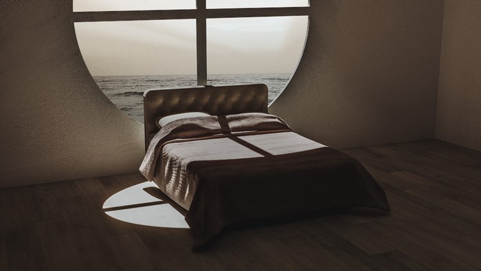 Bedroom with a large circular window overlooking the ocean