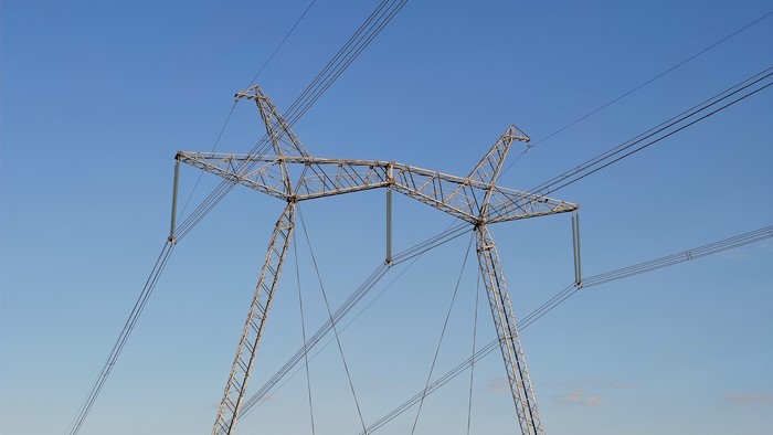 Power lines against a clear blue sky