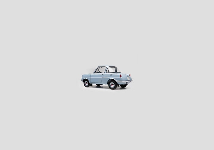 Light blue k-car on a gray background