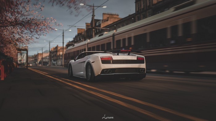 White Lamborghini Gallardo driving past a train in Forza Horizon 4