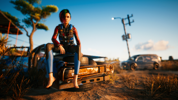 Judy Alvarez from Cyberpunk 2077 sitting on a car
