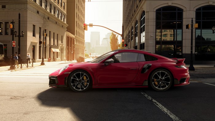 Red Porsche 911 Turbo S sports car on a city street