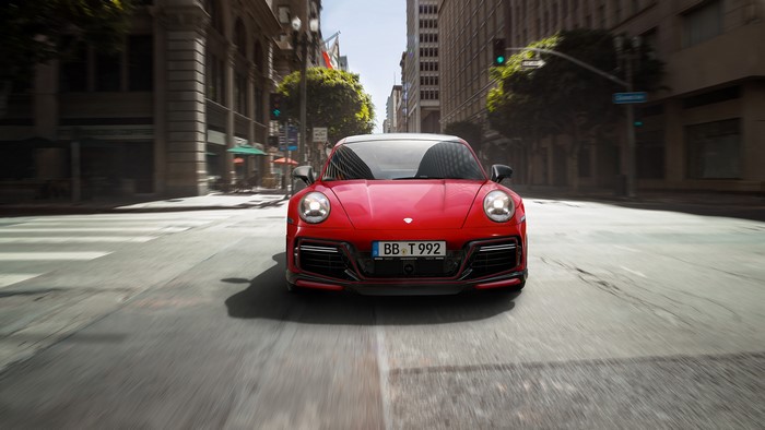 Red Porsche 992 sports car on a city street