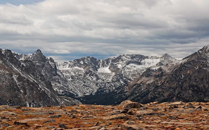 Rocky Mountains landscape with snow and clouds