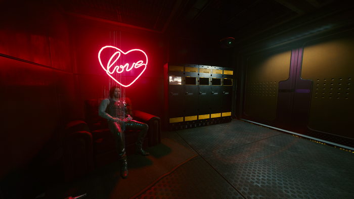 Cyberpunk 2077 screenshot of a man sitting by a neon sign
