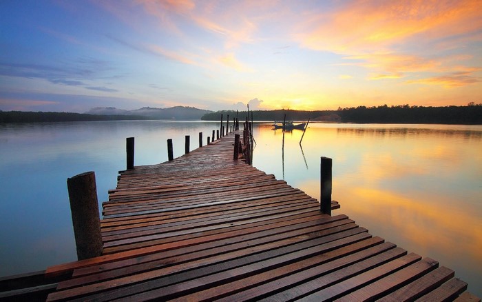 Wooden pier on a lake at sunset