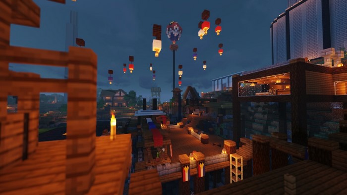 Minecraft village at night with lanterns and buildings