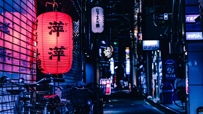 Red lantern and bicycles on a Japanese street at night